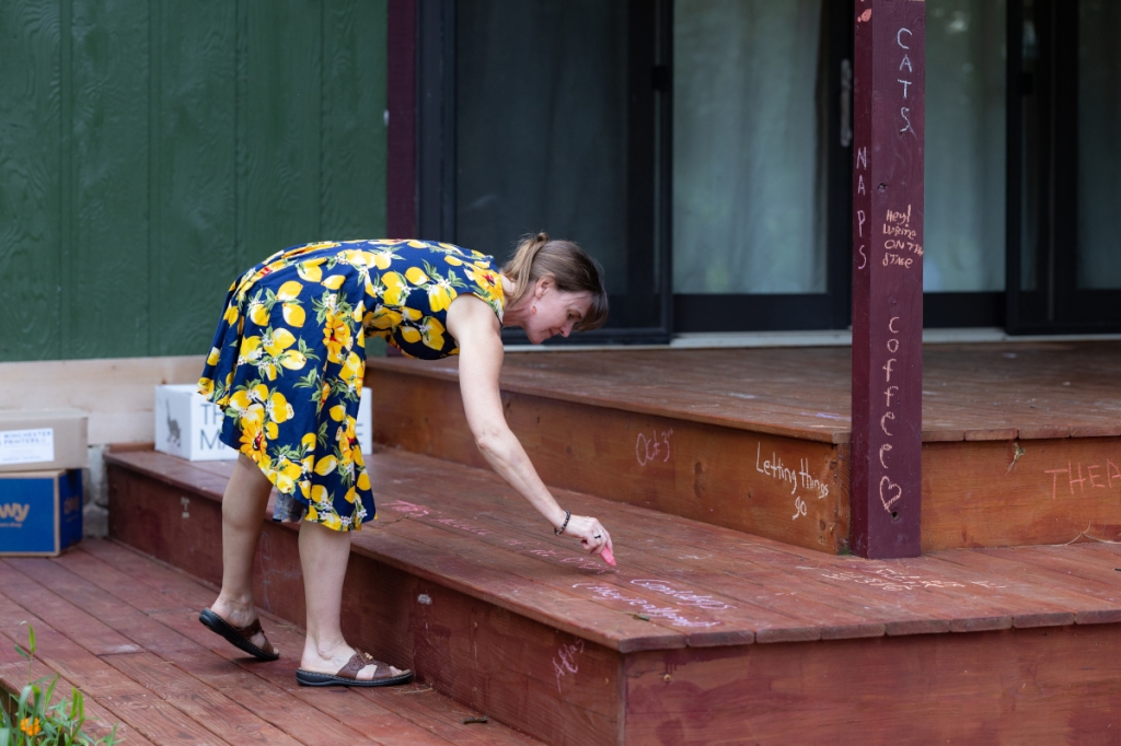 An audience member writes in chalk on the stage.